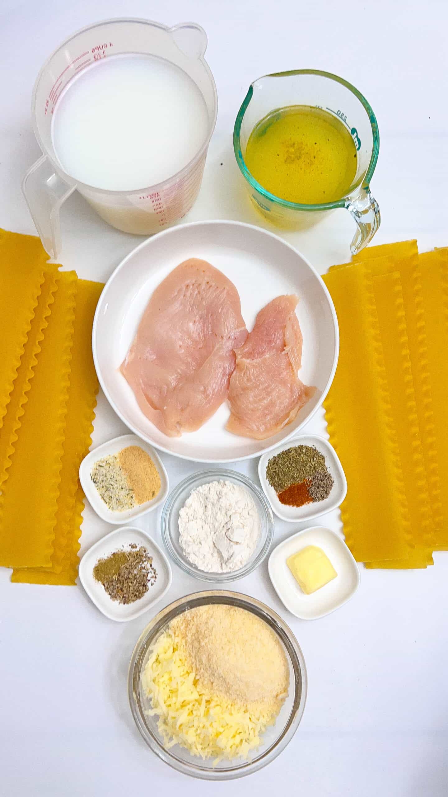 Ingredients for Crockpot Chicken Alfredo Lasagna Soup with chicken, cheese, and seasonings.