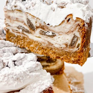 Delicious Muddy Buddy Cheesecake with powdered sugar topping.