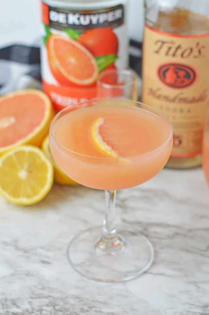Refreshing grapefruit martini with citrus slice garnish on a cocktail glass.
