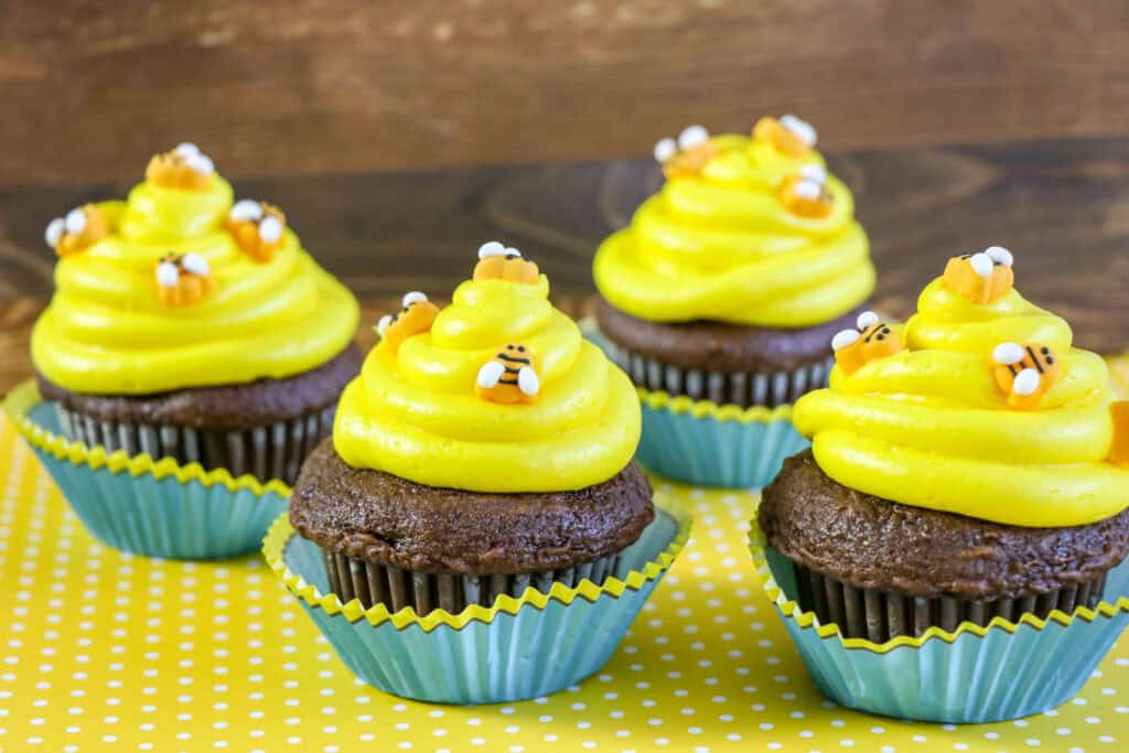 Beehive Cupcakes with yellow frosting and bee decorations.