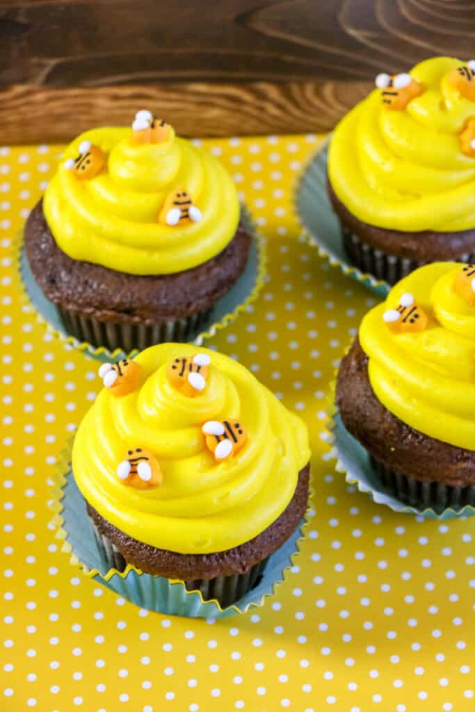 Beehive Cupcakes with yellow frosting and bee decorations.