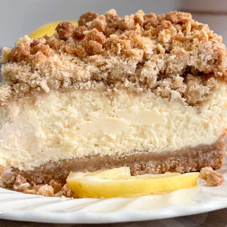 Delicious thick bakery-style lemon cream crumb cheesecake with a crunchy topping.