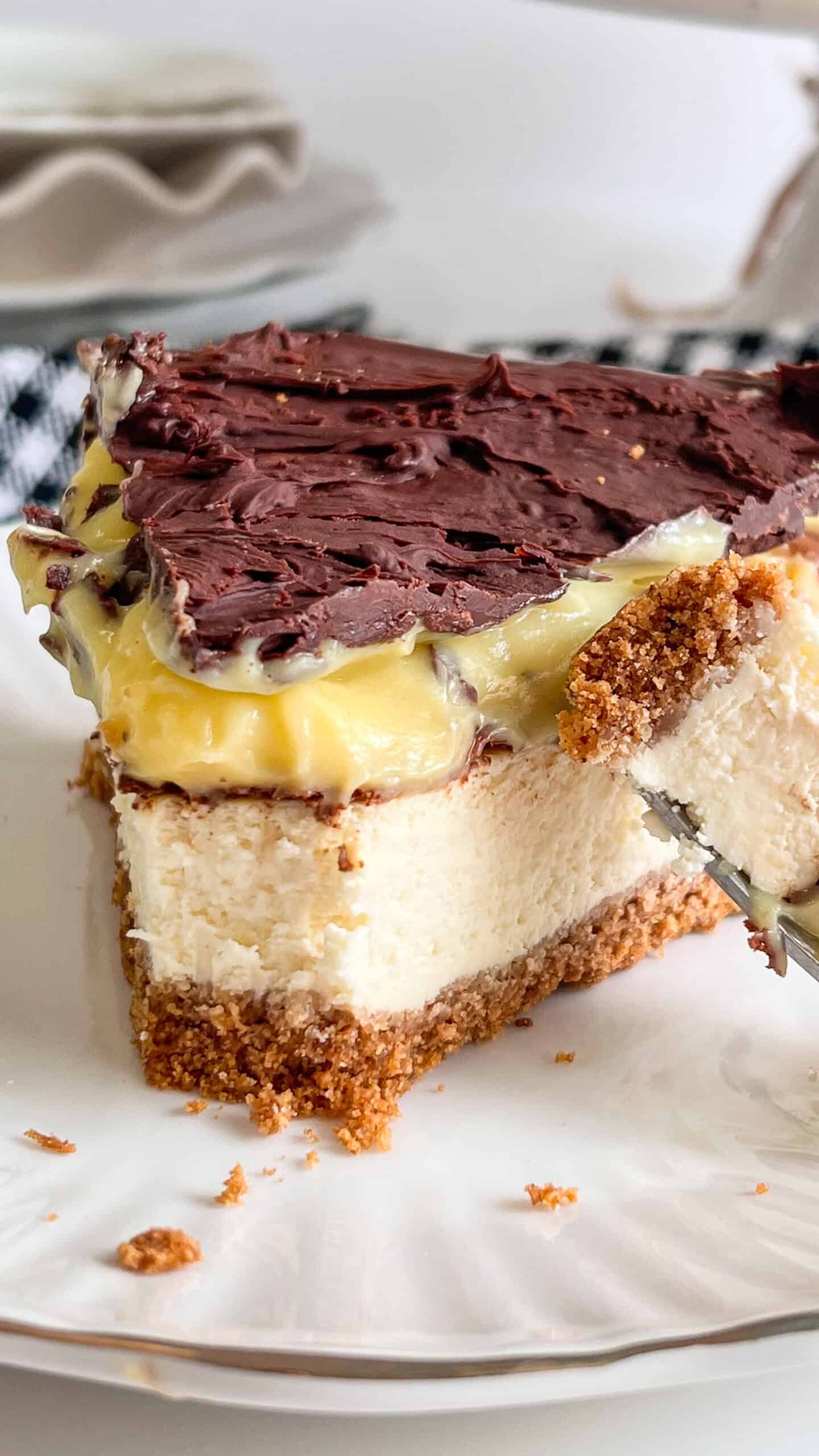 Two classic desserts come together in one unforgettable treat! This Boston Cream Pie Cheesecake features a rich, creamy vanilla cheesecake layered with silky pastry cream, all nestled on a buttery crust and topped with a luscious chocolate ganache. Every bite is the perfect combination of smooth cheesecake, velvety custard, and decadent chocolate. via @Mooreorlesscook
