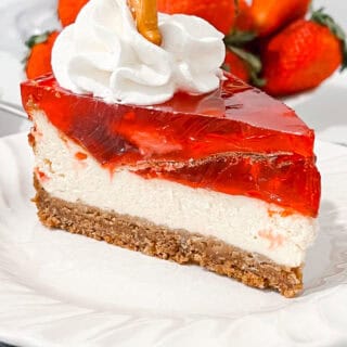 Delicious strawberry cheesecake with creamy filling and fresh strawberries on top.