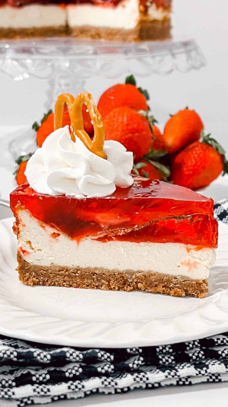Delicious strawberry cheesecake slice topped with whipped cream and caramel, perfect for dessert lov.