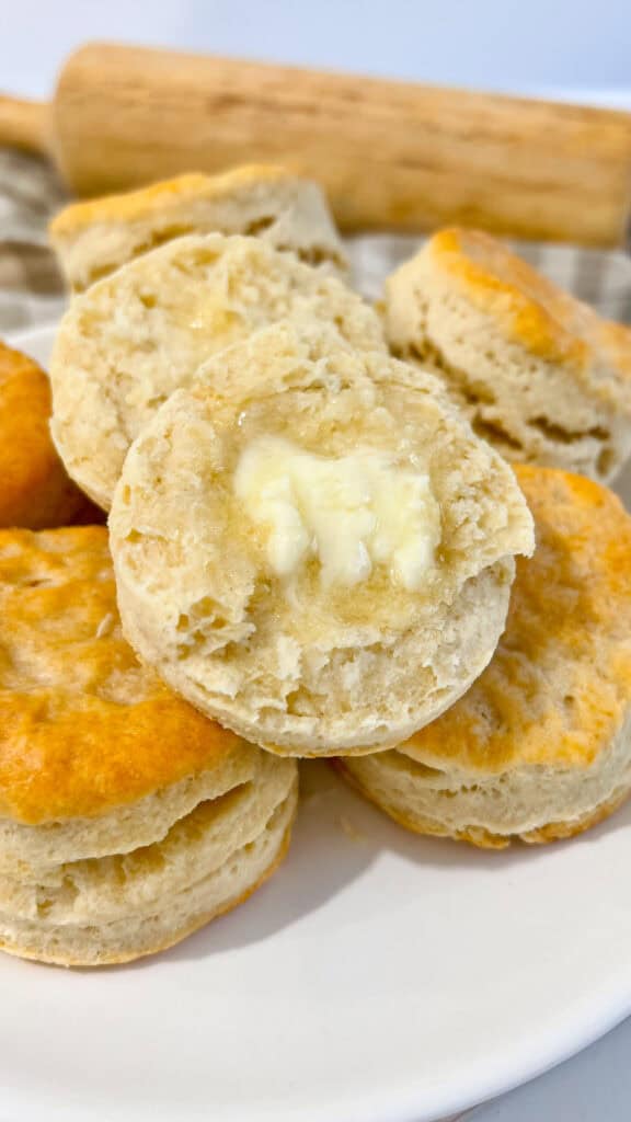 baked and stacked Sourdough Discard Buttermilk Biscuits with melted butter