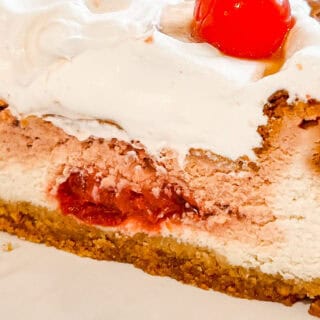 Close-up of Cherry Coke Cheesecake with cherries on top.