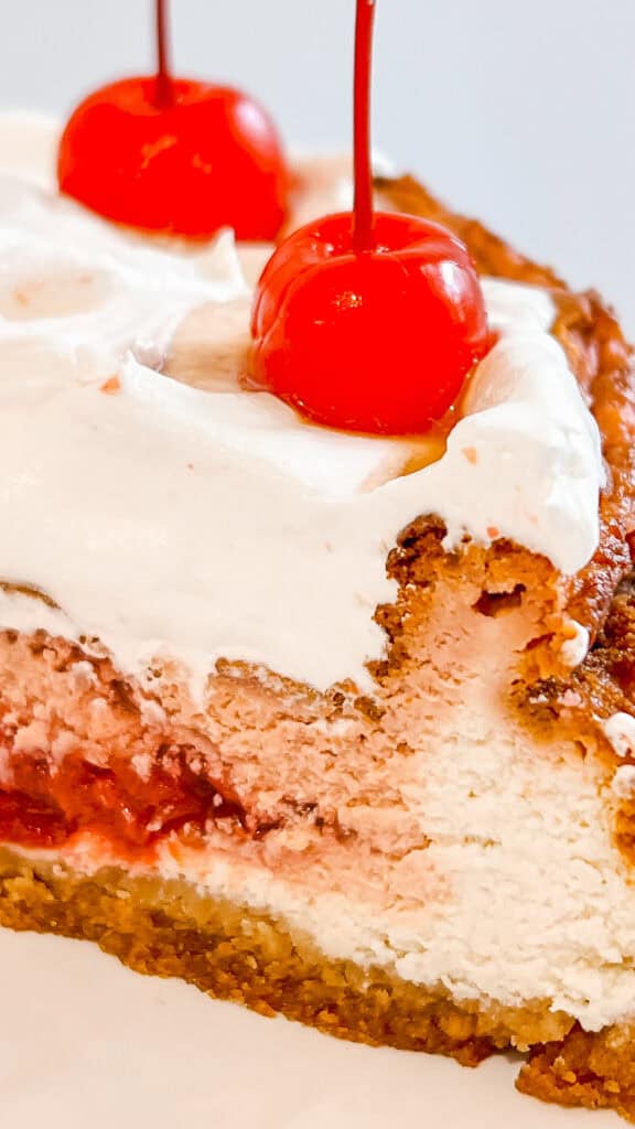 Close-up of Cherry Coke Cheesecake with cherries on top.