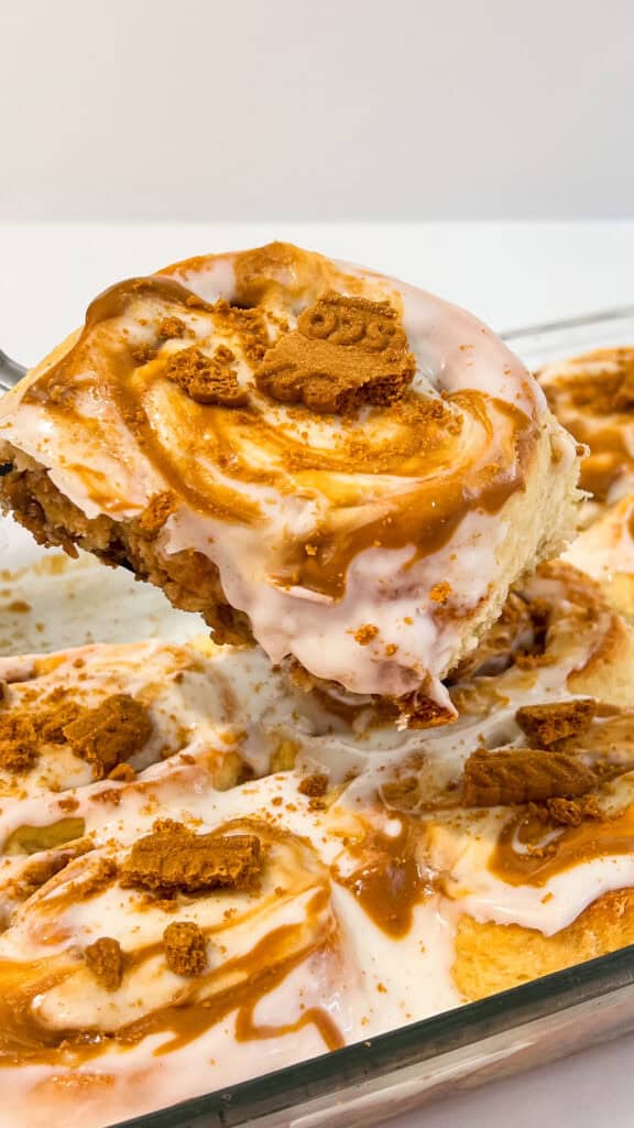 Close-up of Biscoff cinnamon rolls topped with cookie butter and caramel drizzle.