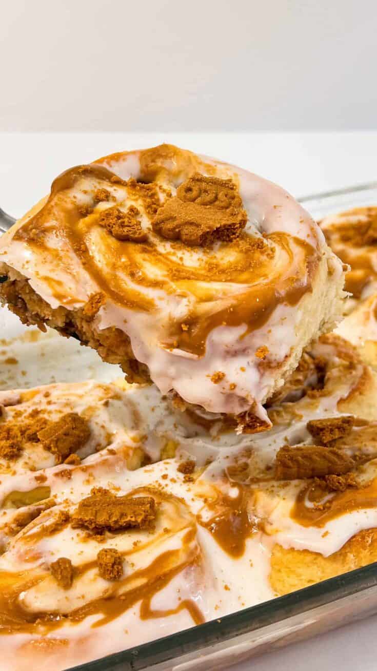 Close-up of Biscoff cinnamon rolls topped with cookie butter and caramel drizzle.